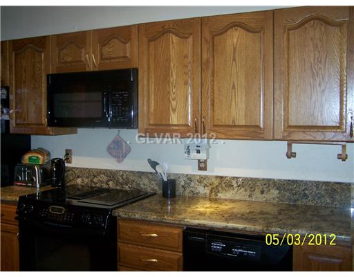 8820 Rancho Destino Road Las Vegas, NV 89123 - Photo 9 of 13 Kitchen. LOTS OF ROOM IN THIS KITCHEN WITH UPGRADED CABINETRY, RICH GRANITE COUNTERS, DOUBLE SINKS AND BAR SINK LOTS OF COUTER TOP AND STORAGE.