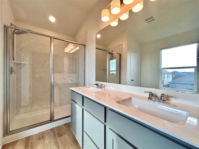 a bathroom with a sink double vanity and shower