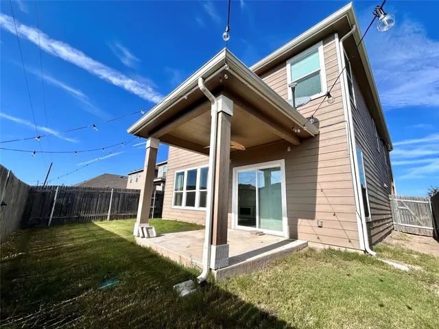 a view of a house with backyard and porch