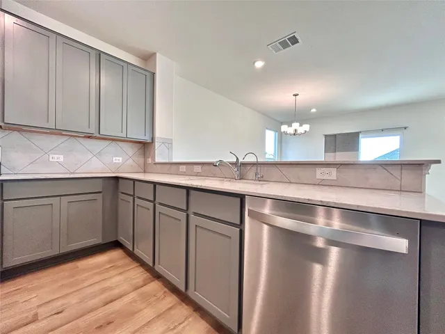 a kitchen with kitchen island granite countertop stainless steel appliances a sink and cabinets
