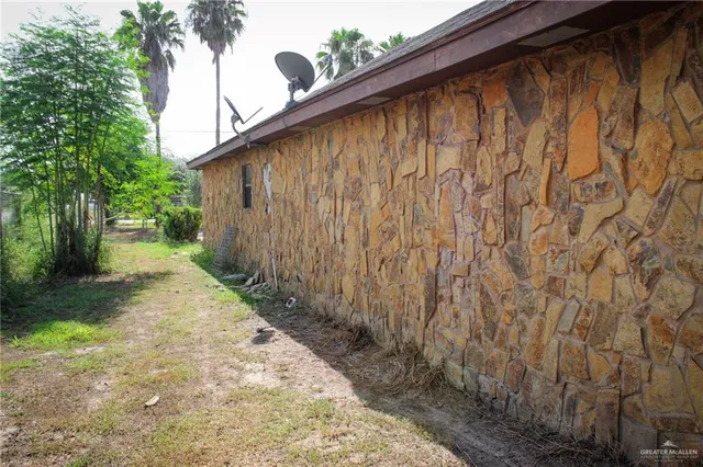 a backyard of a house with plants and trees