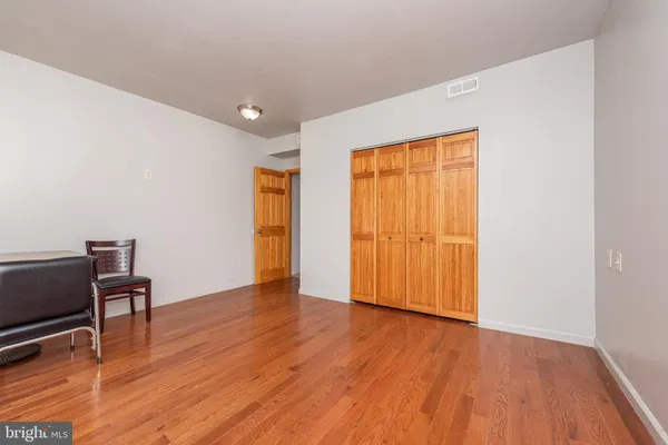 a view of a room with wooden floor