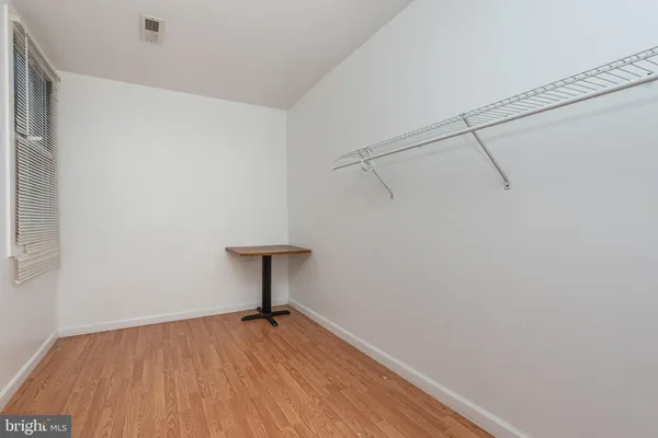 a view of workspace with wooden floor and a window