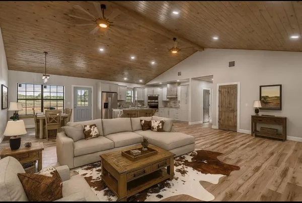 a kitchen with white cabinets and appliances