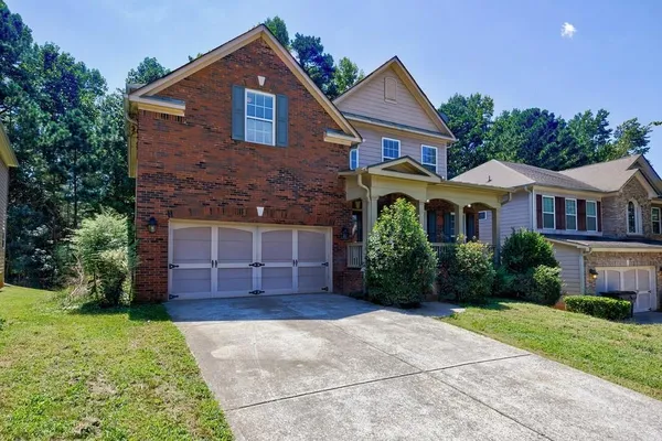 a front view of a house with a yard