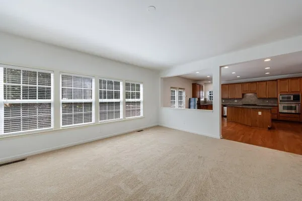a bathroom with a sink vanity granite tub shower and a mirror