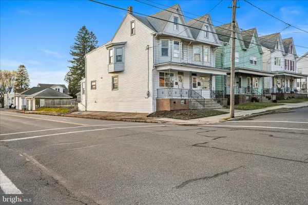a view of a brick building next to a road