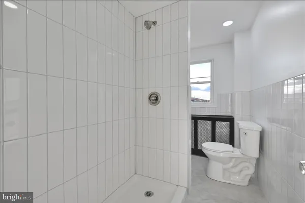 a view of an empty room with window and cabinet