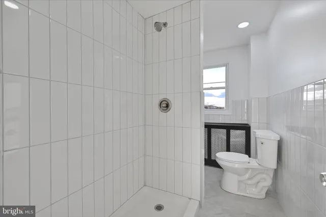a view of an empty room with window and cabinet