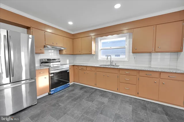 a kitchen with granite countertop white cabinets sink and window