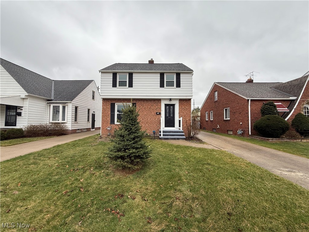 6807 Gerald Avenue Parma, OH 44129 - Photo 1 of 25 View of front of house with brick siding and a front yard