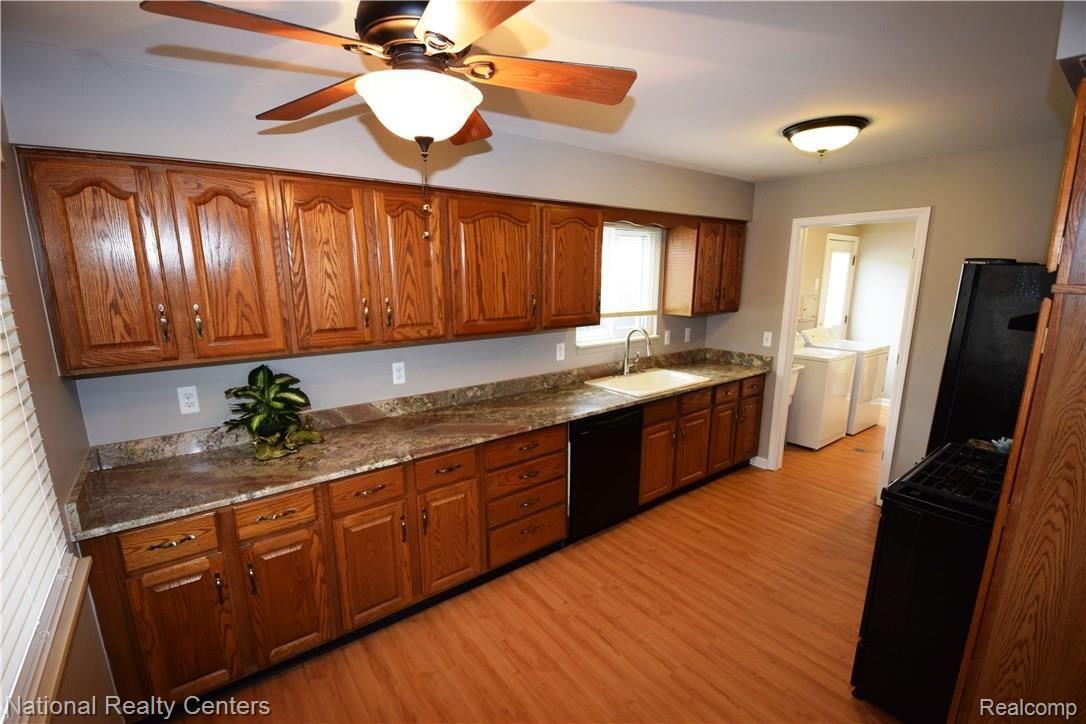 Kitchen view includes granite counters and all appliances shown
