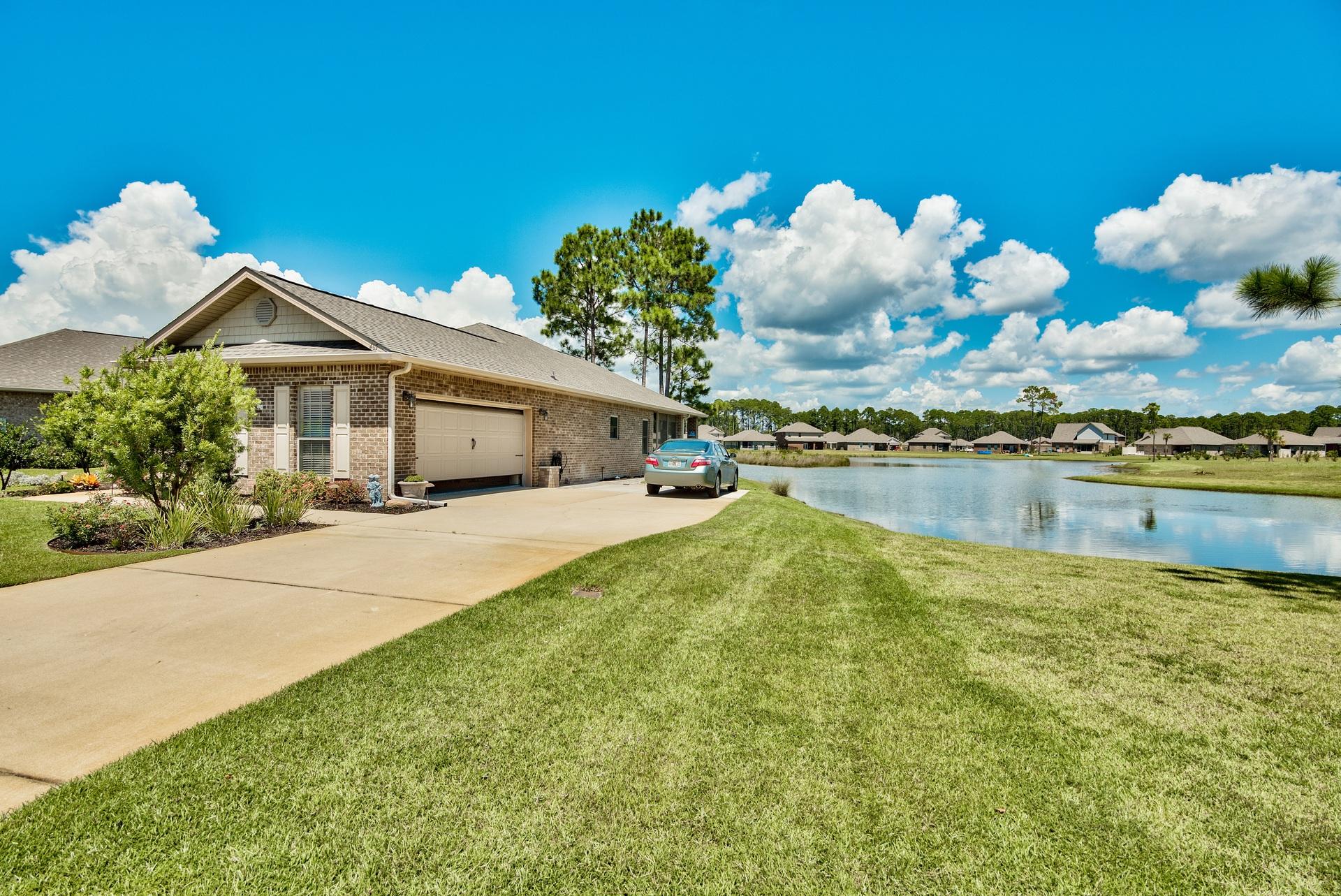 465 Pin Oak Loop Santa Rosa Beach, FL 32459 - Photo 1 of 38 a front view of a house with garden