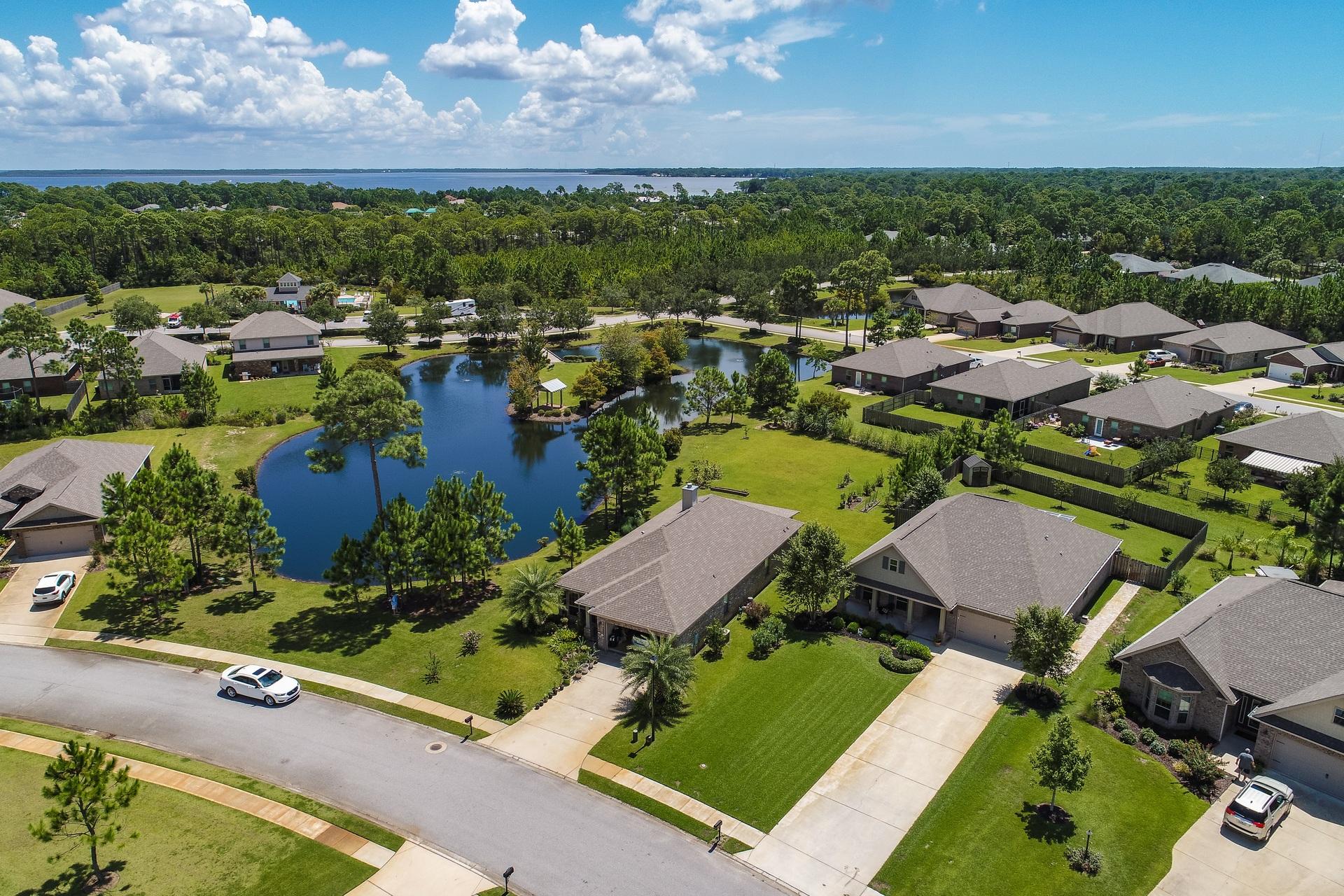 465 Pin Oak Loop Santa Rosa Beach, FL 32459 - Photo 27 of 38 an aerial view of a house with a garden and lake view
