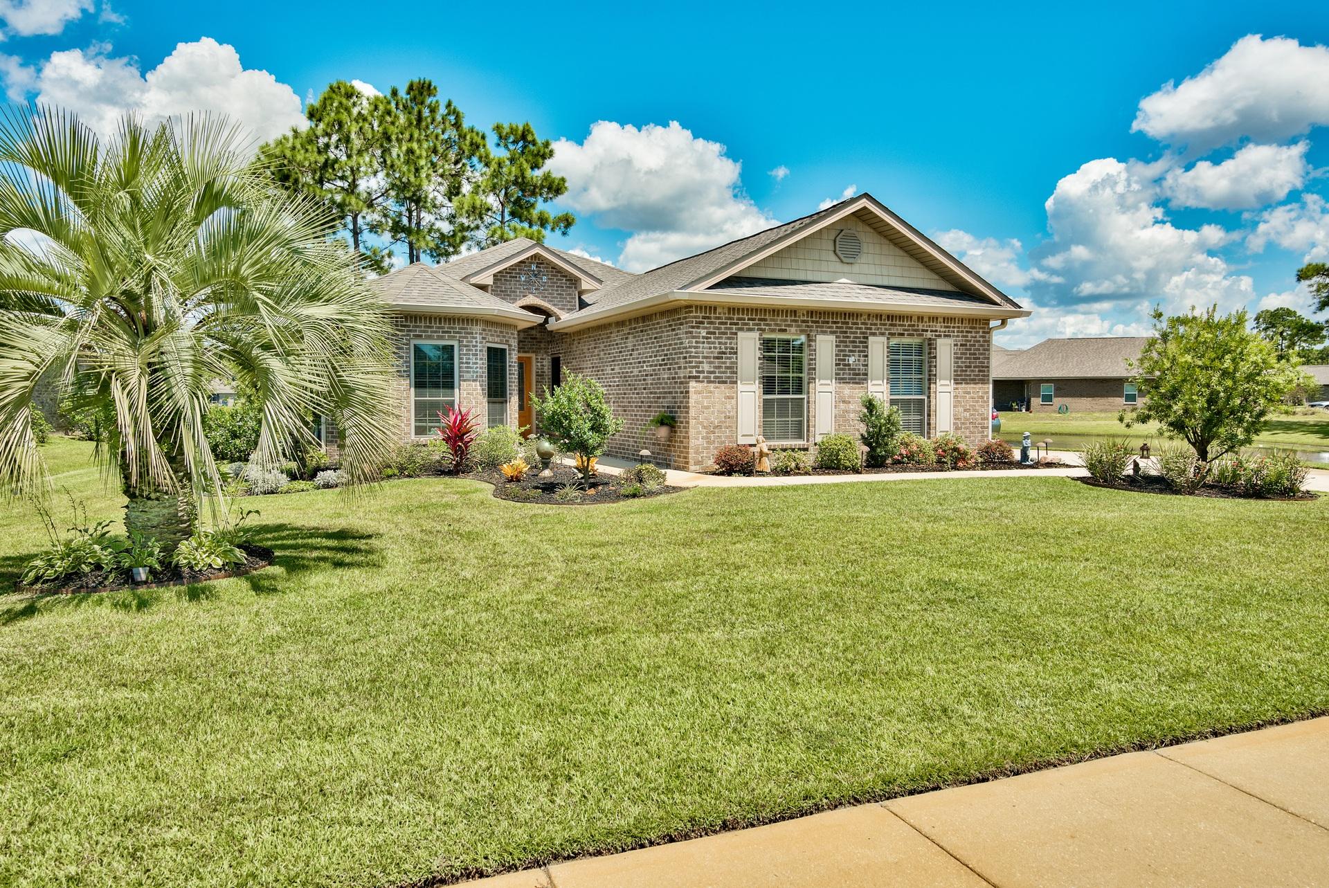 465 Pin Oak Loop Santa Rosa Beach, FL 32459 - Photo 3 of 38 a front view of a house with garden
