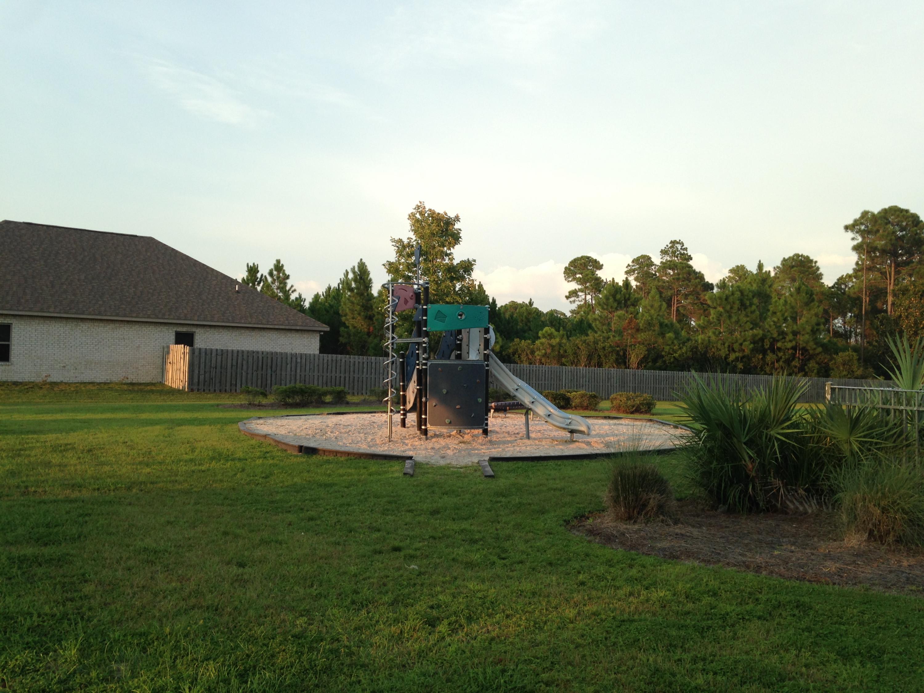 465 Pin Oak Loop Santa Rosa Beach, FL 32459 - Photo 33 of 38 a view of a house with pool and a yard