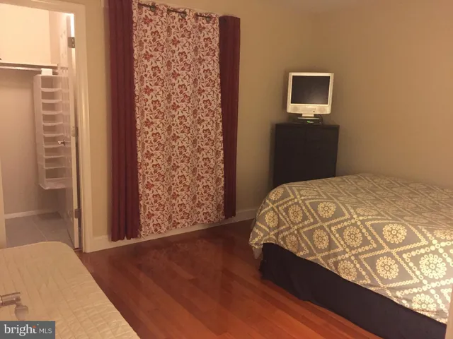 a bedroom with a bed and a tv