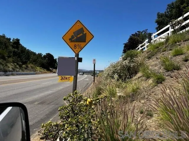 26945 Valley Center Road Valley Center, CA 92082 - Photo 16 of 17 a street sign on a wall next to road