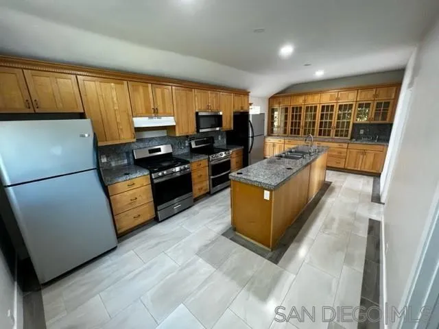 26945 Valley Center Road Valley Center, CA 92082 - Photo 4 of 17 a kitchen with granite countertop stainless steel appliances and wooden cabinets