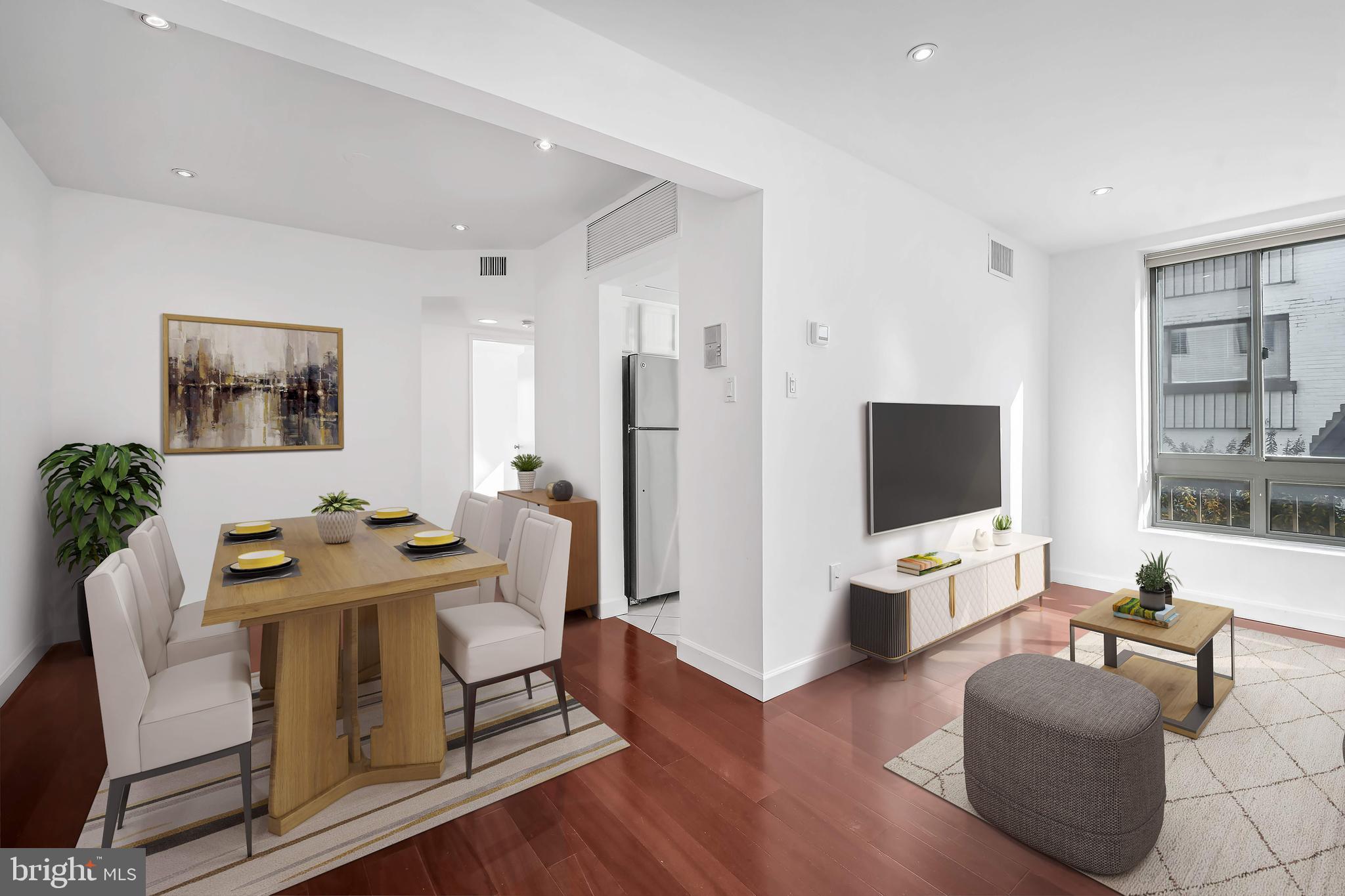 2610 Tunlaw Road Northwest, Unit 104 Washington, DC 20007 - Photo 2 of 20 a living room with furniture a flat screen tv and a large window