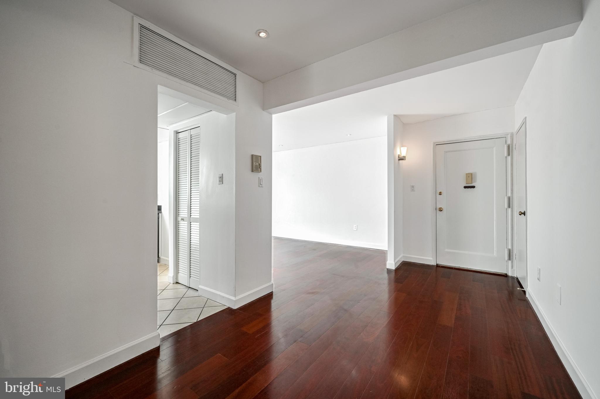 2610 Tunlaw Road Northwest, Unit 104 Washington, DC 20007 - Photo 5 of 20 wooden floor in an empty room
