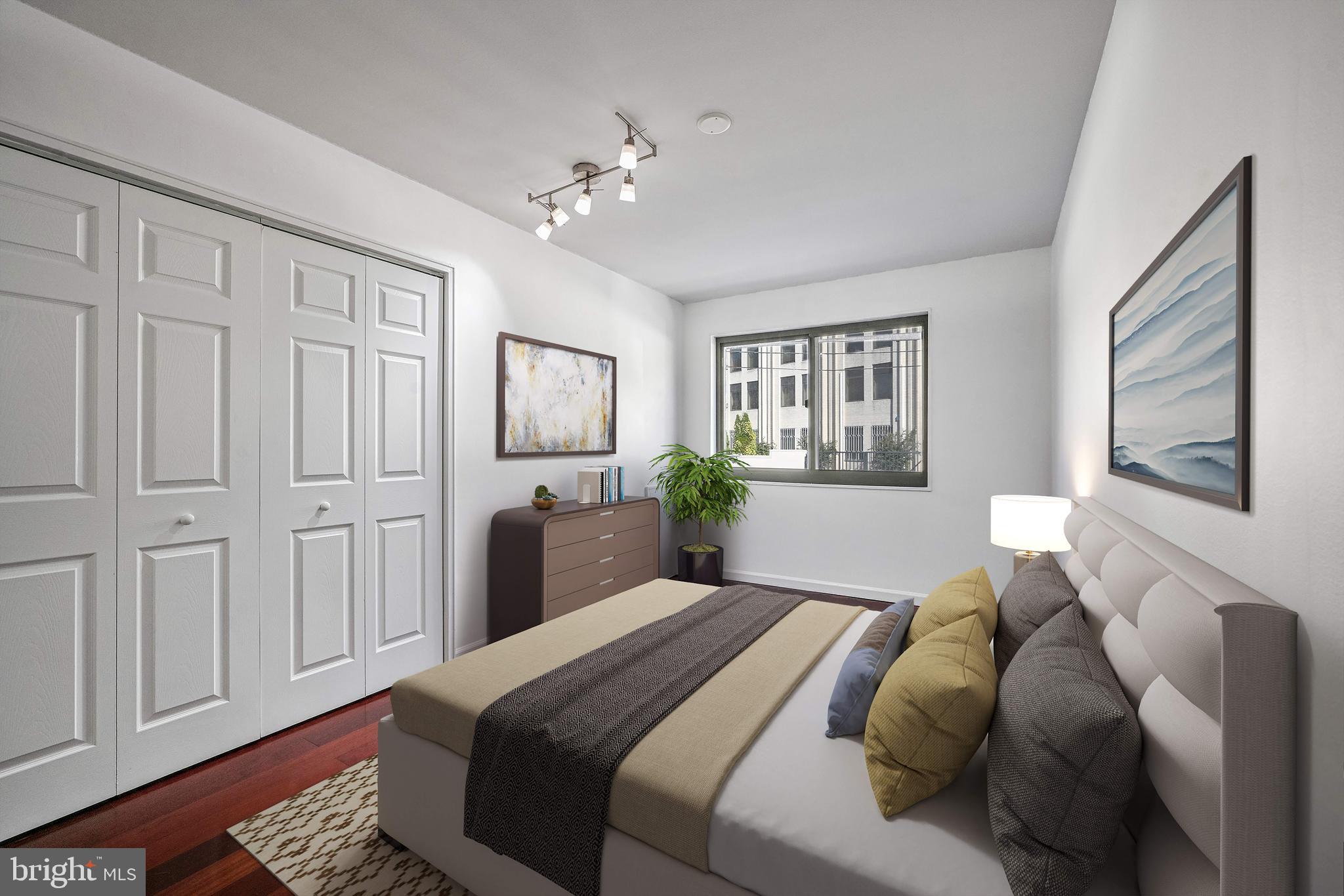 2610 Tunlaw Road Northwest, Unit 104 Washington, DC 20007 - Photo 8 of 20 a bedroom with a large bed and a chandelier