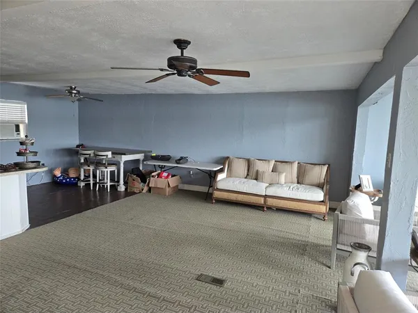a view of a livingroom with furniture and a ceiling fan