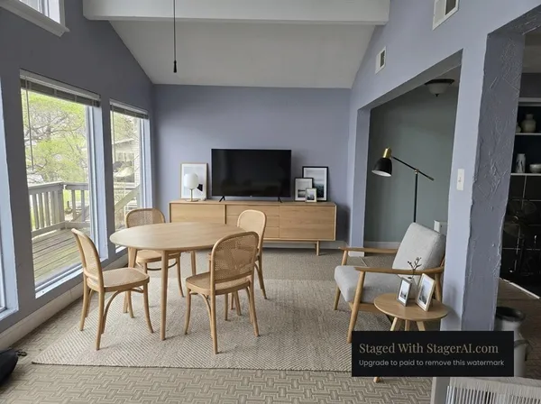 a view of a livingroom with furniture window and wooden floor