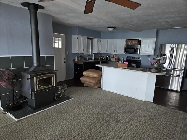 a kitchen with a sink a counter top space appliances and a window