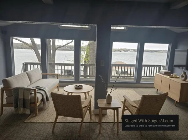 a view of a dining room with furniture a chandelier and wooden floor