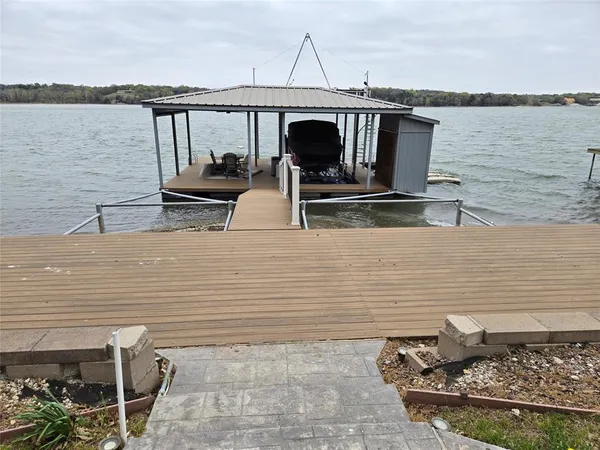 a view of roof deck with chairs and wooden floor