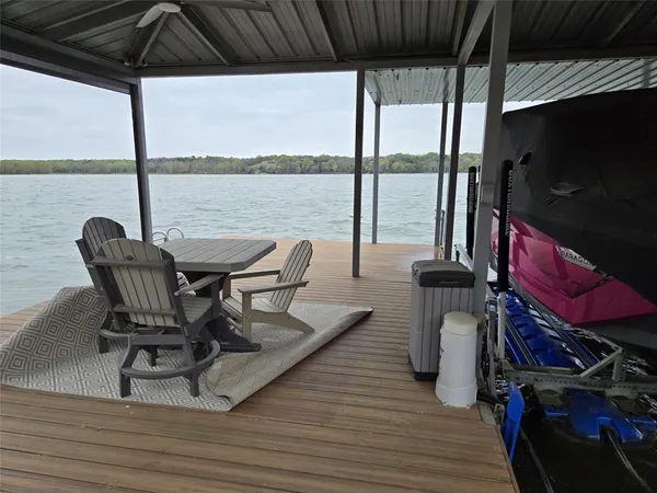 a roof deck with table and chairs