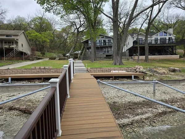a view of a patio with chairs next to a yard