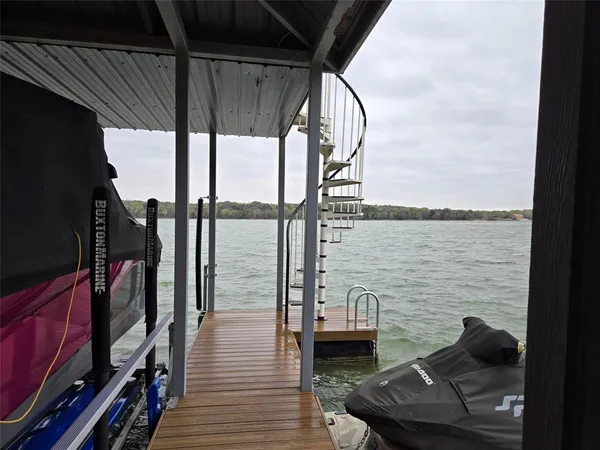 a view of a balcony with chair and wooden floor