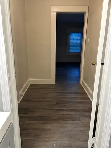 a view of hallway with wooden floor
