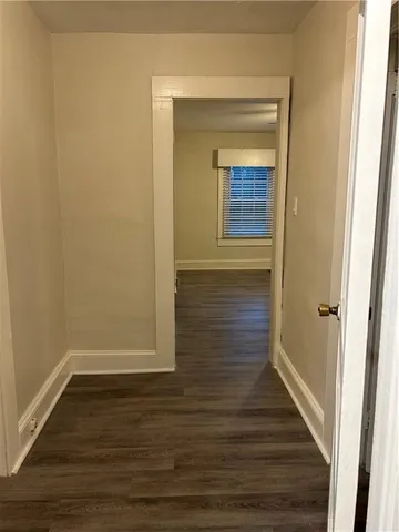 a view of hallway with wooden floor