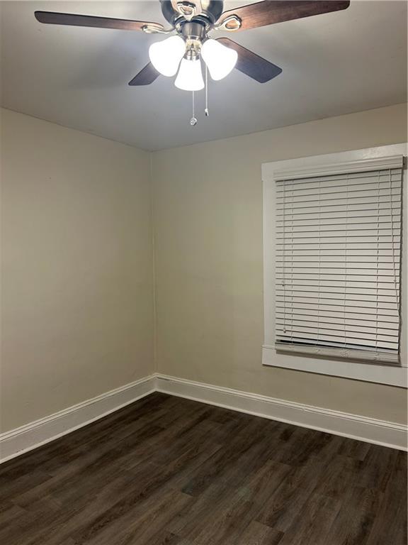 180 Harlan Road Southwest Atlanta, GA 30311 - Photo 18 of 20 a view of an empty room with wooden floor and a fan