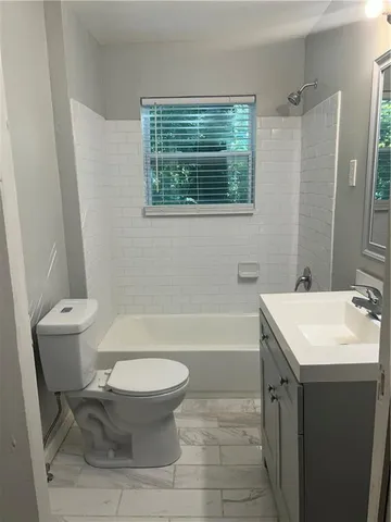 a bathroom with a sink toilet and a bathtub