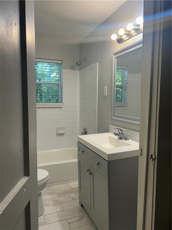 180 Harlan Road Southwest Atlanta, GA 30311 - Photo 6 of 20 a bathroom with a sink a toilet and shower