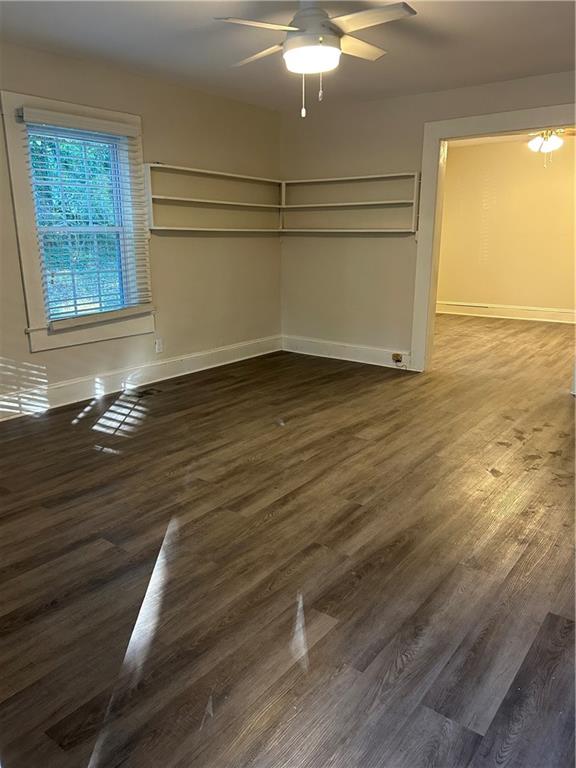 180 Harlan Road Southwest Atlanta, GA 30311 - Photo 7 of 20 wooden floor in an empty room with a window
