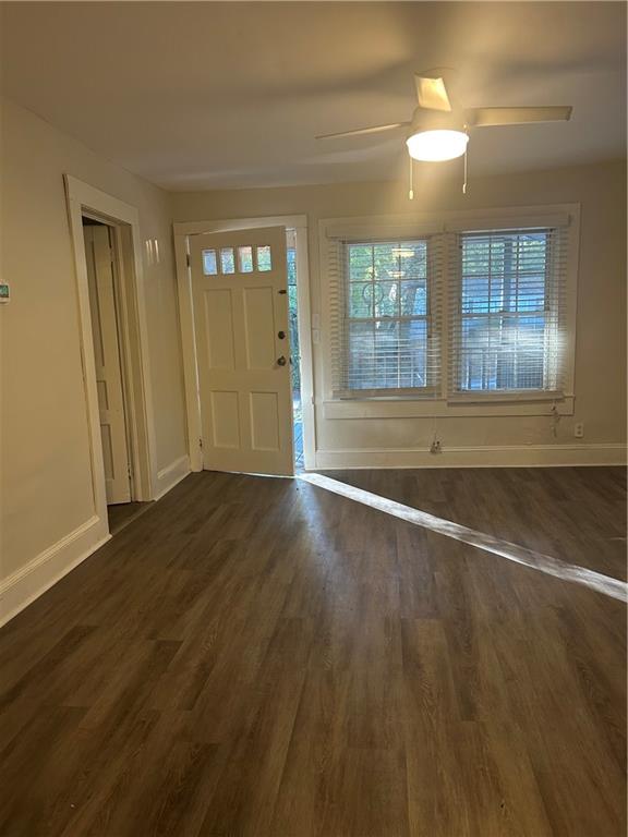 180 Harlan Road Southwest Atlanta, GA 30311 - Photo 8 of 20 an empty room with wooden floor and windows