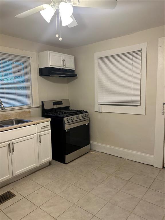 180 Harlan Road Southwest Atlanta, GA 30311 - Photo 10 of 20 a kitchen with stainless steel appliances granite countertop a stove a sink and a refrigerator