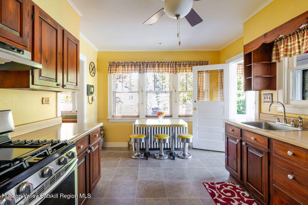 6 Hawley Road Niverville, NY 12130 - Photo 13 of 36 a kitchen with a stove a sink a dining table and chairs