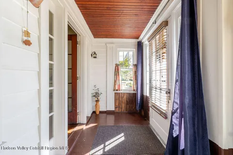 a view of hallway with furniture and a large window