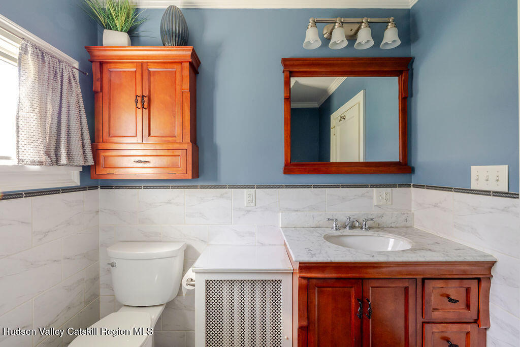 6 Hawley Road Niverville, NY 12130 - Photo 29 of 36 a bathroom with a sink a toilet and mirror