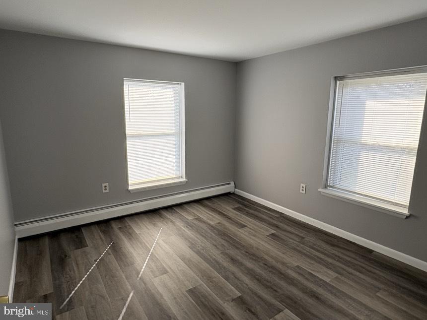 613 Laudermilch Road, Unit 2 Hummelstown, PA 17036 - Photo 13 of 16 a view of an empty room with wooden floor and a window