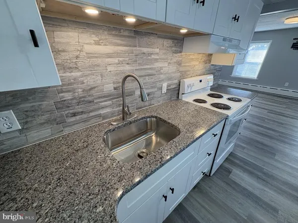 a kitchen with stainless steel appliances granite countertop a stove and a refrigerator