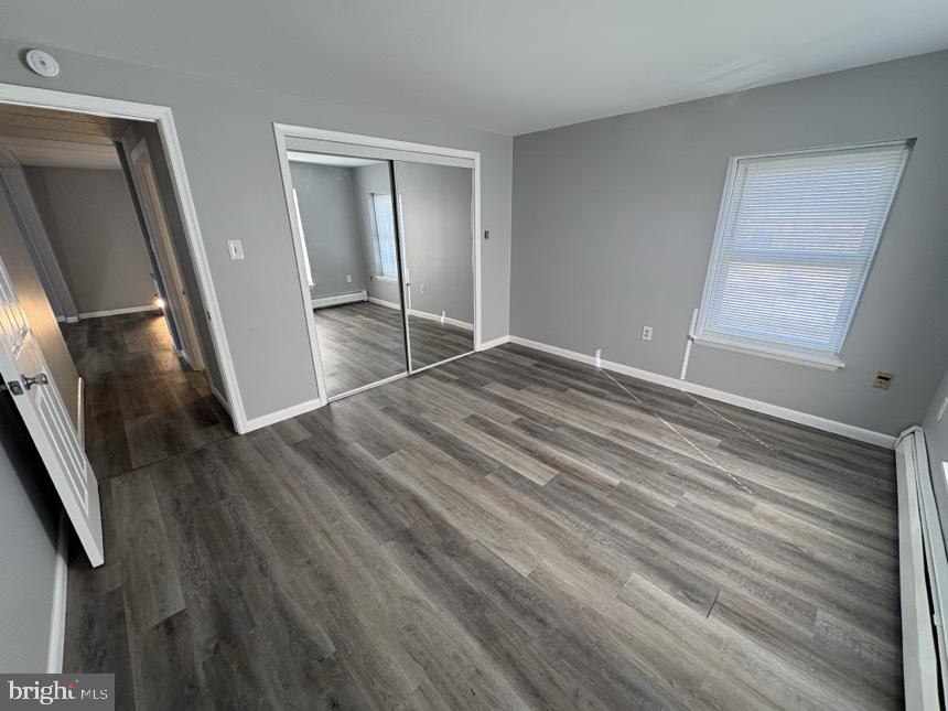 613 Laudermilch Road, Unit 2 Hummelstown, PA 17036 - Photo 8 of 16 a view of an empty room with wooden floor and a window