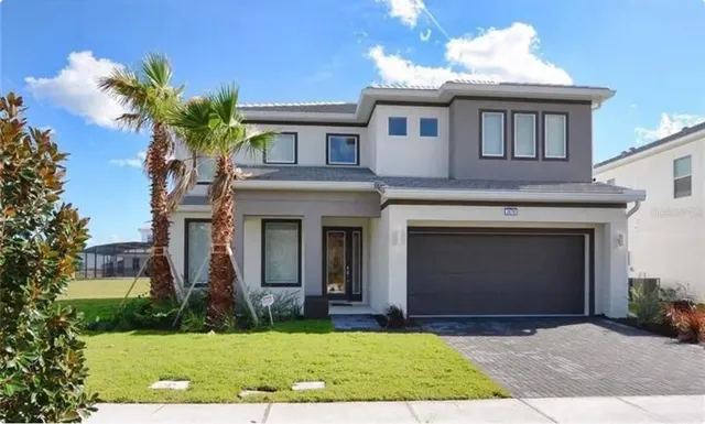 a front view of a house with a yard and garage