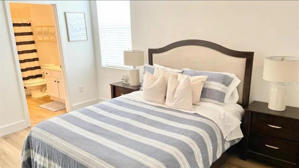 2676 Calistoga Avenue Kissimmee, FL 34741 - Photo 14 of 30 a bedroom with a bed and a window with outer view